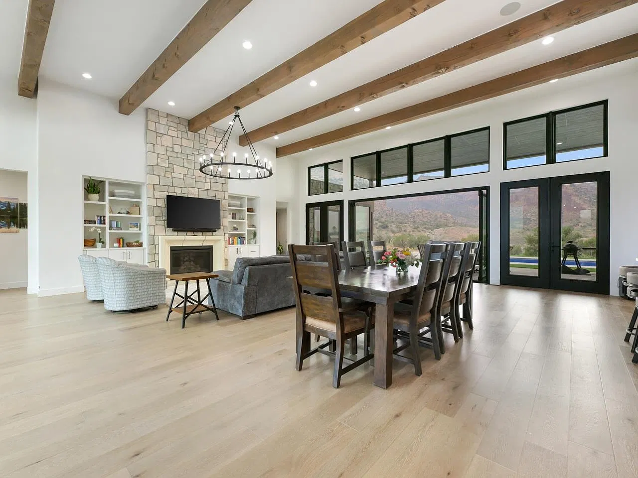 Dining area with stone fireplace and walls of glass