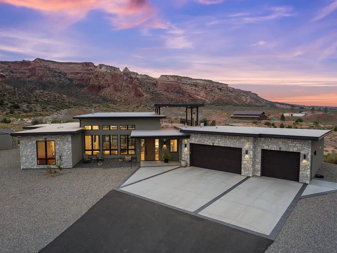 Front of 1843 Broadway at dusk with red rock cliffs behind