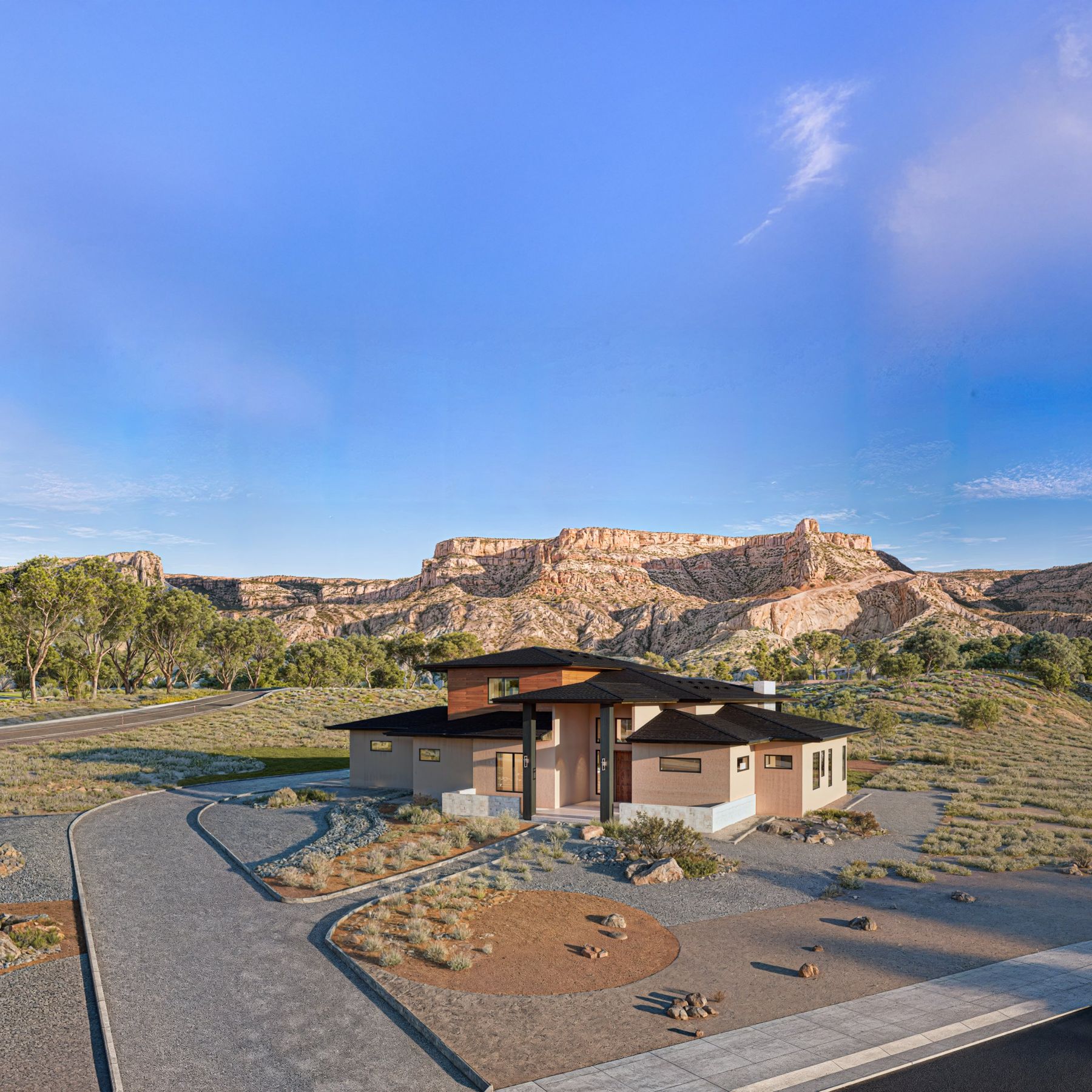 Aerial view of the home and landscaped drive with the mesa behind