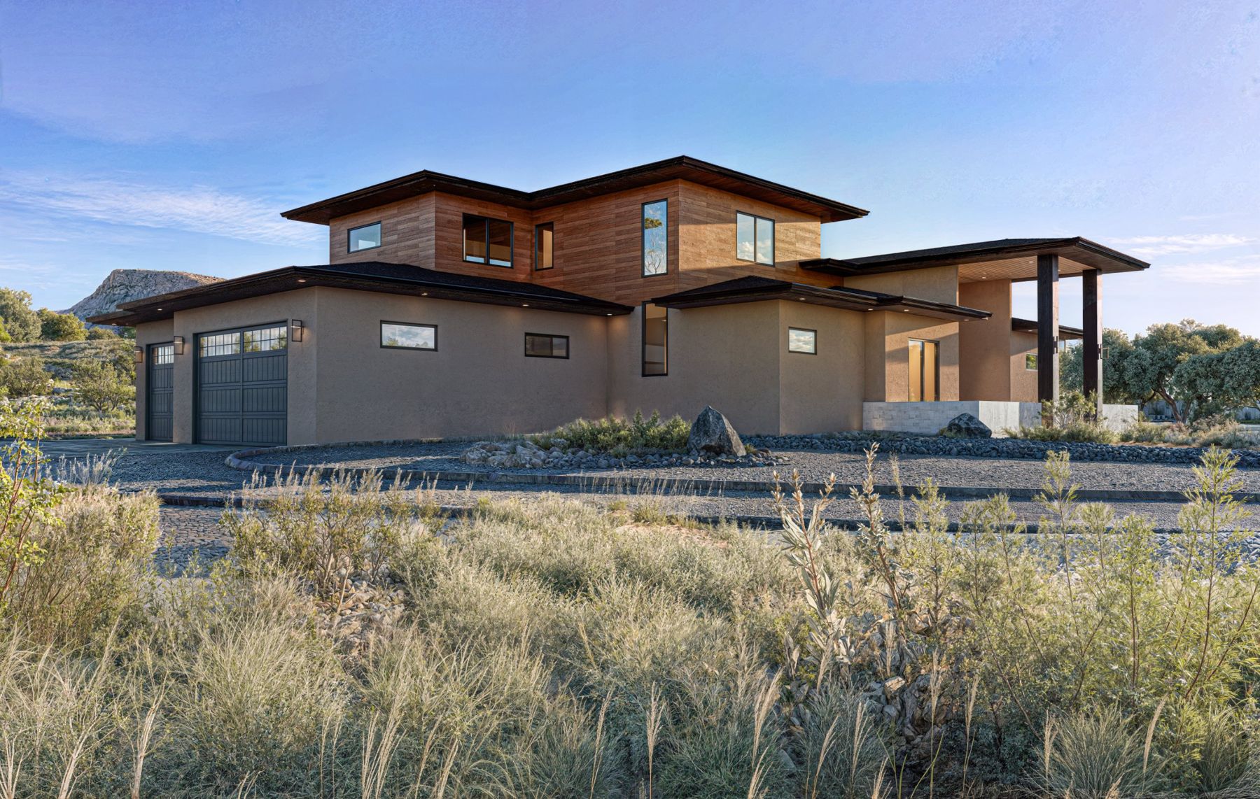 Side view with the garage and two-story wood-clad upper level