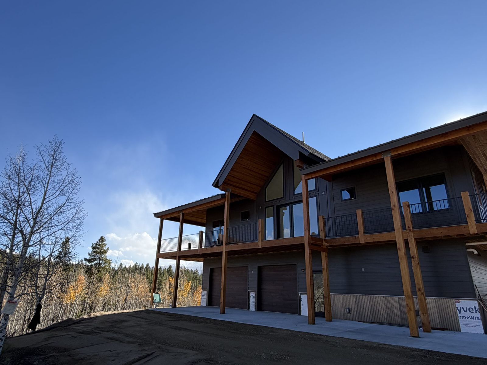 A new mountain home with the site graded and finished around it